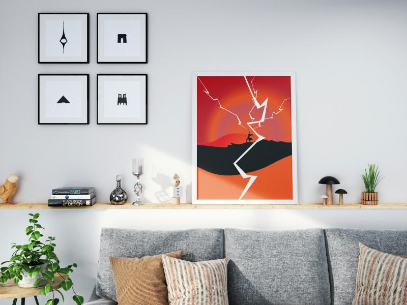 Bold graphic wall art propped on a floating shelf above a modern gray sofa, demonstrating a sleek and renter-friendly way to display artwork without nails.